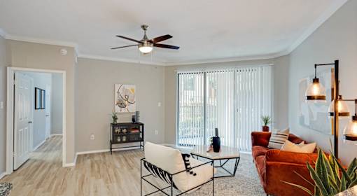 A living room with a ceiling fan and a couch.