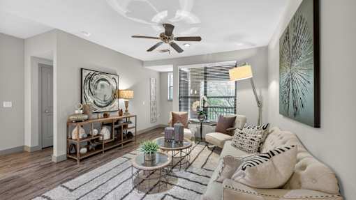 A living room with a white sofa and a glass coffee table.