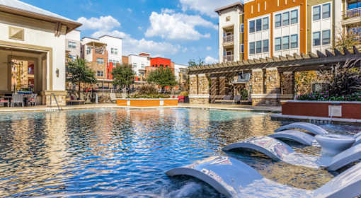 A pool with a water slide in the middle of it.