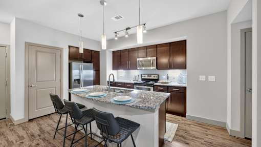 A kitchen with a table and chairs.