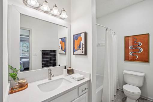 A bathroom with a white toilet and a white sink.