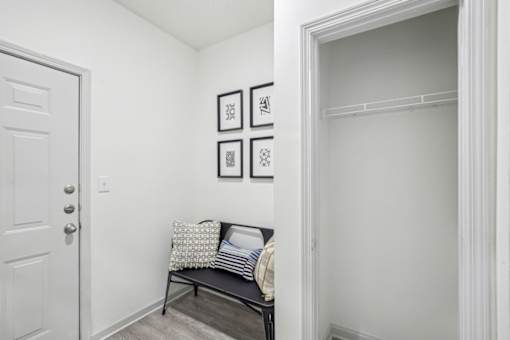 A hallway with a bench and pictures on the wall.