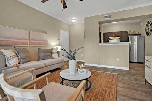 A living room with a couch, chairs, and a coffee table.