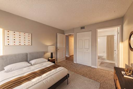 A bedroom with a large bed and a mirror on the wall.