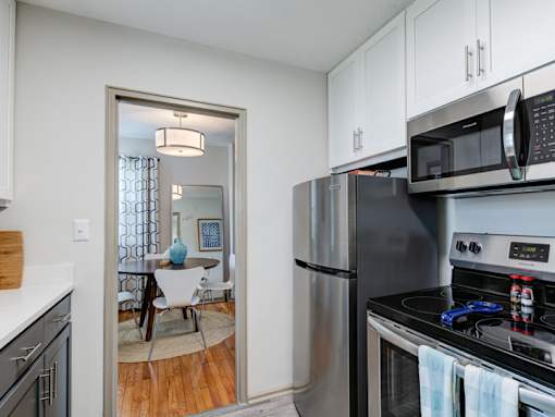 A modern kitchen with a stainless steel refrigerator and microwave.