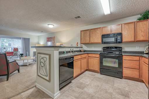A kitchen with a black oven and microwave.