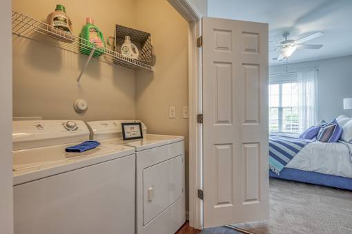 A white door is open to a bedroom.