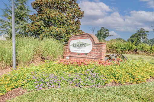 A sign that says Reserve is in front of a grassy area.