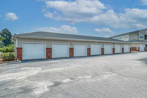 A row of garage doors in front of a building.
