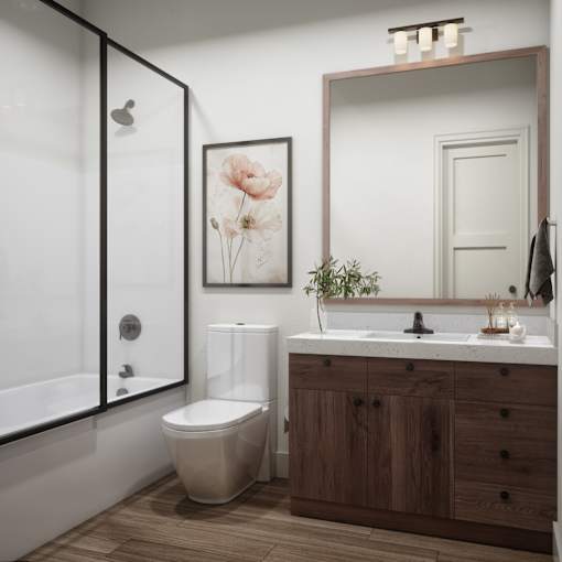 A bathroom with a toilet, sink, and mirror.
