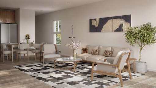 A modern living room with a large sofa, a coffee table, and a painting on the wall.