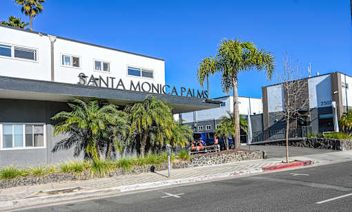 A street view of the Santa Monica Palms building with a clear blue sky.
