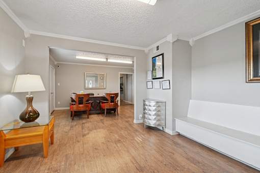 A living room with a wooden floor and furniture.
