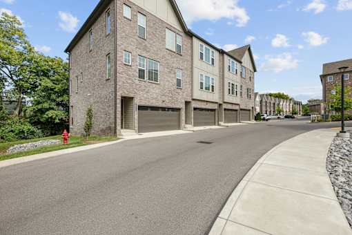 A street view of a residential area with apartment buildings.