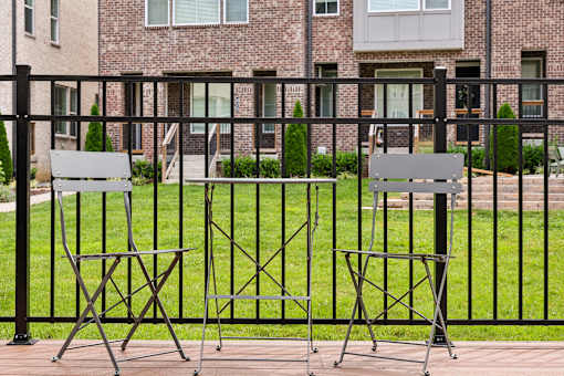 Two chairs and a table are set up on a patio.