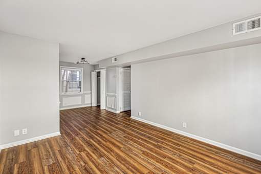 A room with wooden floors and white walls.