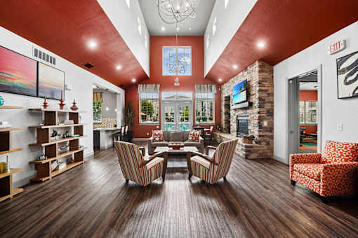 A living room with a wooden floor and a large window.
