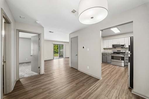 A modern kitchen with a refrigerator, oven, and sink.