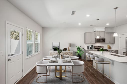 an open kitchen and dining room with a table and chairs