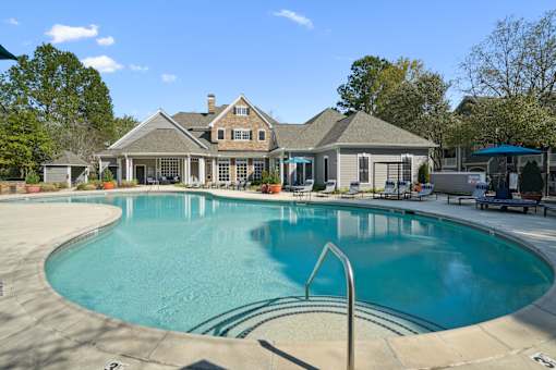 A large house with a pool in front.