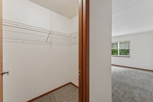 Empty room with a carpeted floor and a window.