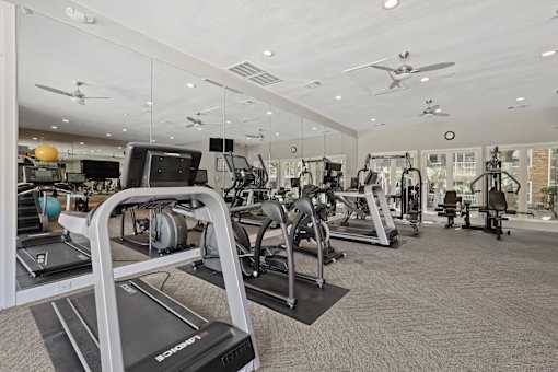 A gym with treadmills and other exercise equipment.