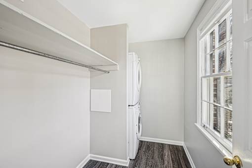 A white refrigerator in a room with a window.
