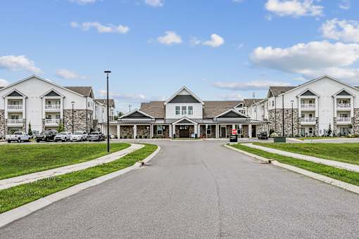 A row of houses with a driveway in front.