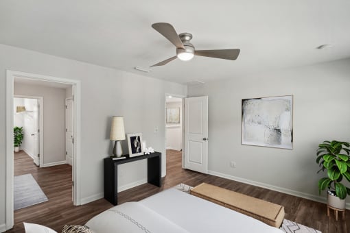 a bedroom with a large bed and a ceiling fan