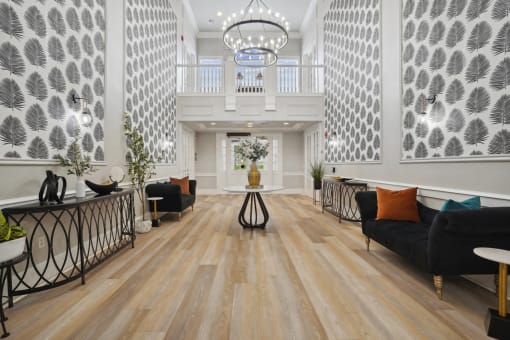 the lobby of a hotel with couches and a table