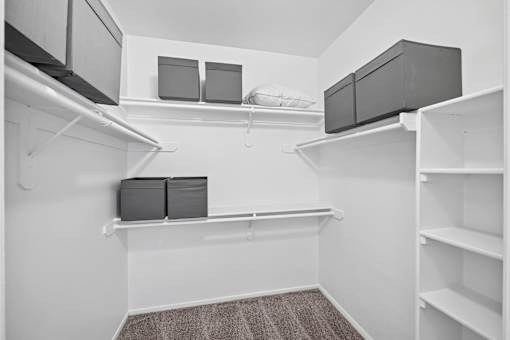A white room with shelves and storage boxes.