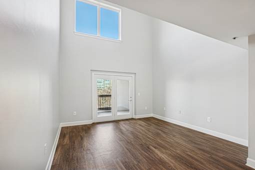 A room with a wooden floor and a window.