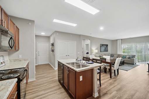 A modern kitchen with wooden cabinets and a central island.