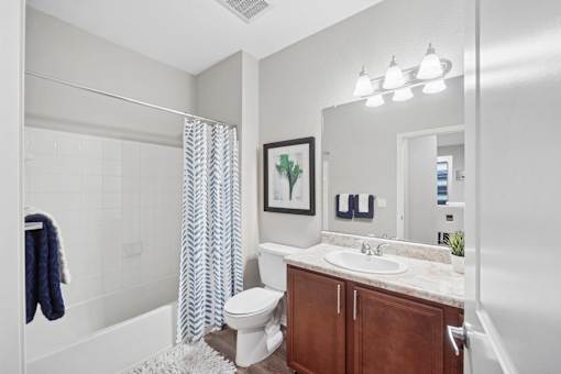 A bathroom with a white sink and a white toilet.