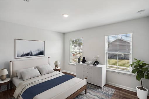 a bedroom with a bed and two windows