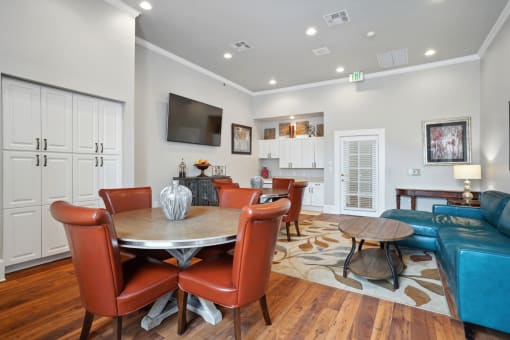 a living room with a table and chairs and a television