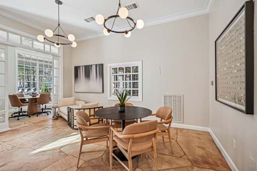 A modern dining room with a round table and chairs.