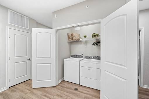 A white laundry room with a washer and dryer.
