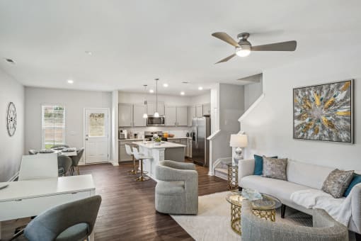 an open living room and kitchen with a ceiling fan
