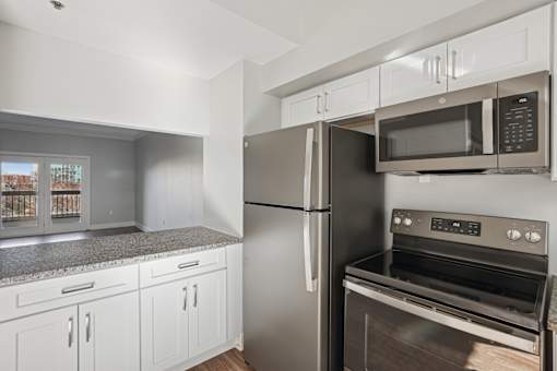 A kitchen with a stainless steel refrigerator and oven.