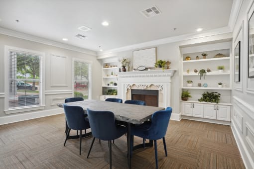 a dining room with a table and chairs in front of a fireplace