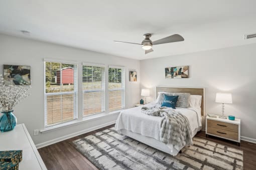 a bedroom with a bed and a ceiling fan
