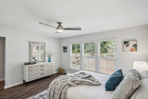a bedroom with a large bed and a ceiling fan