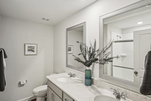 a white bathroom with a sink and a mirror