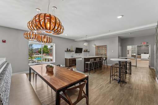 A modern kitchen with a wooden table and chairs.