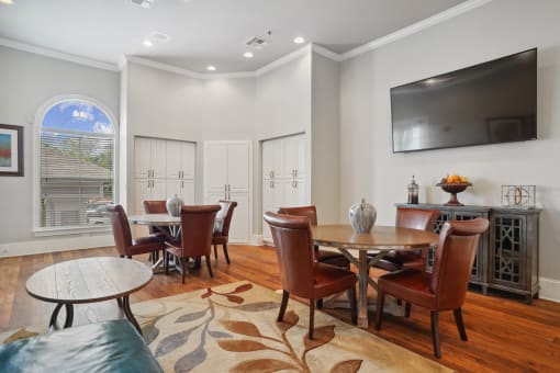 a living room with a table and chairs and a television
