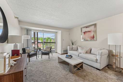 A living room with a white couch and a coffee table.