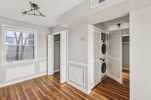 A room with a window, a door, and a ceiling fan.
