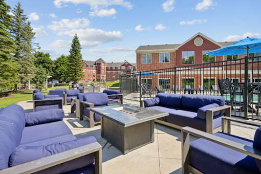 A patio with blue couches and a table.