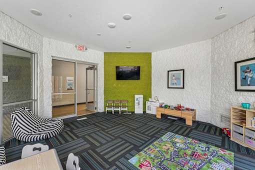 A room with a green wall and a television on it.